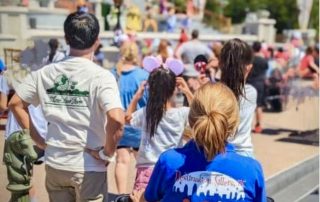 A trusted babysitter from Destination Sitters engaging with children at Disney World.